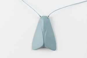 Light blue butterfly-shaped pendant on a thin string against a white background
