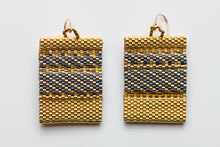 Load image into Gallery viewer, Pair of gold earrings with blue striped pattern on a light gray background
