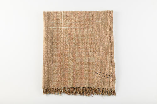 Textured brown blanket with frayed edges on a white background
