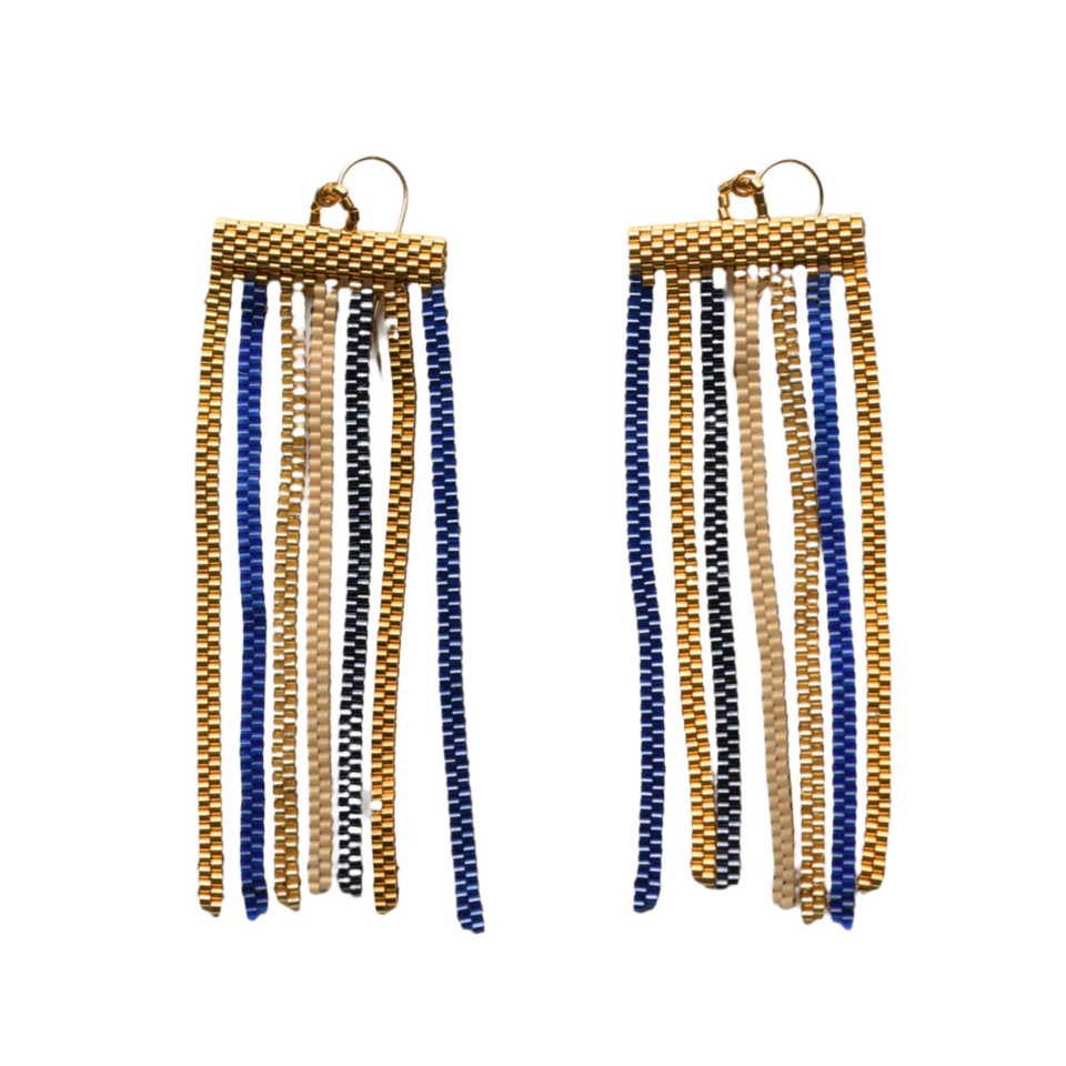 Pair of gold and blue tassel earrings on a white background